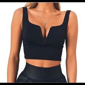 Black crop top with a zipper on the side .